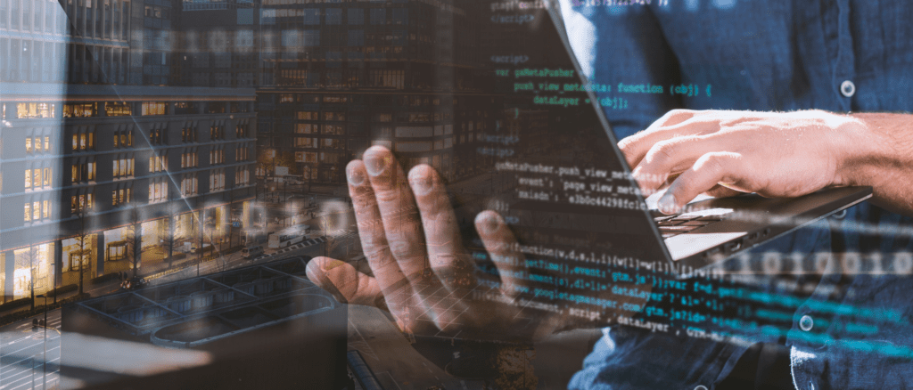 man holding laptop wearing blue shirt